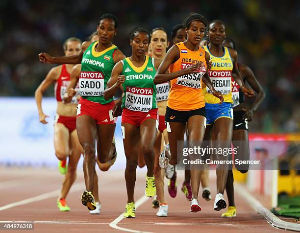 Dawit Seyaum of Ethiopia and Sifan Hassan of the Netherlands cross the finish line in the Women's 1500 metres semi-final during day two of the 15th...