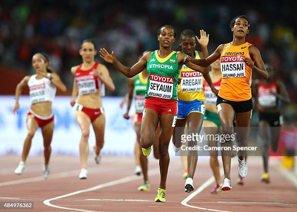 Dawit Seyaum of Ethiopia and Sifan Hassan of the Netherlands cross the finish line in the Women's 1500 metres semi-final during day two of the 15th...