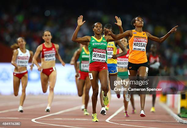 Dawit Seyaum of Ethiopia and Sifan Hassan of the Netherlands cross the finish line in the Women's 1500 metres semi-final during day two of the 15th...