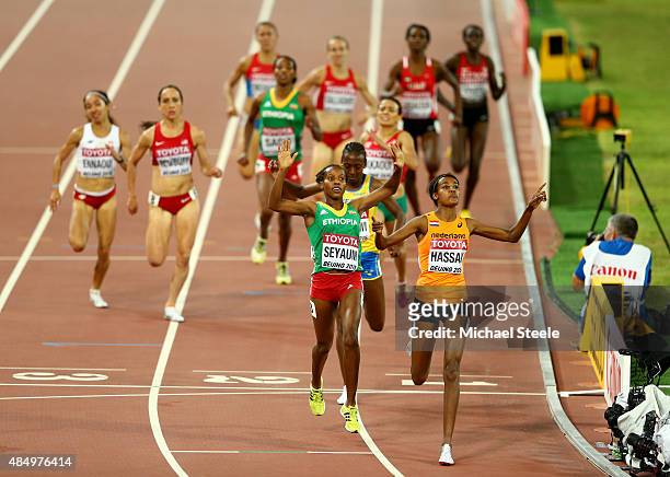 Dawit Seyaum of Ethiopia and Sifan Hassan of the Netherlands cross the finish line in the Women's 1500 metres semi-final during day two of the 15th...