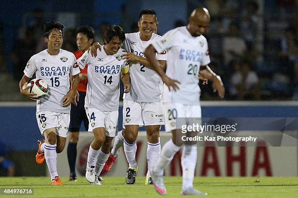 Takeshi Hamada of Tokushima Voltis celebrates scoring his team's first goal with his team mates during the J.League second division match between...