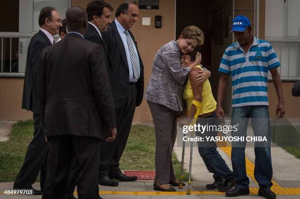 Brazilian President Dilma Rousseff hugs a new owner during the inauguration ceremony of the apartments for 720 families as part of the government's...