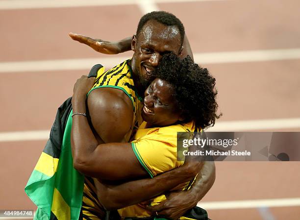 Usain Bolt of Jamaica celebrates with mother Jennifer Bolt after winning gold in the Men's 100 metres final during day two of the 15th IAAF World...