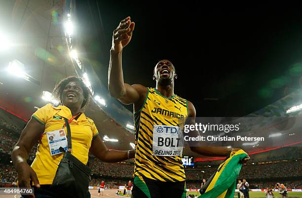 Usain Bolt of Jamaica celebrates with mother Jennifer Bolt after winning gold in the Men's 100 metres final during day two of the 15th IAAF World...