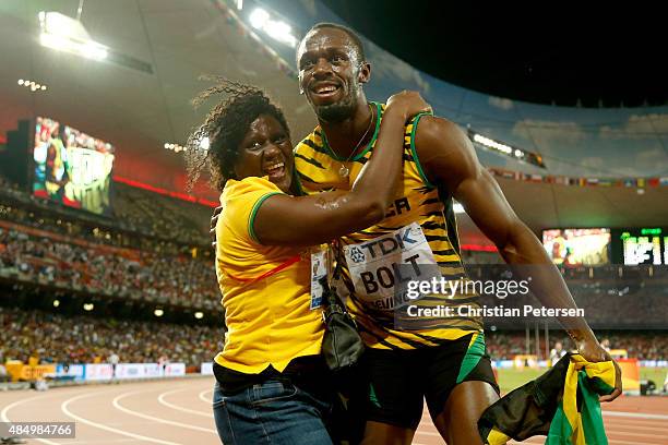 Usain Bolt of Jamaica celebrates with mother Jennifer Bolt after winning gold in the Men's 100 metres final during day two of the 15th IAAF World...