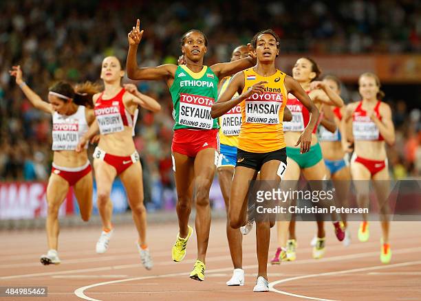 Dawit Seyaum of Ethiopia and Sifan Hassan of the Netherlands cross finish line in the Women's 1500 metres semi-final during day two of the 15th IAAF...