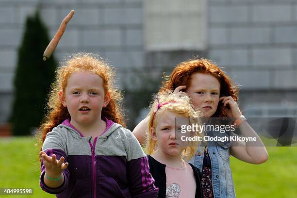 Children participate in the carrot throwing competition at the Irish Redhead Convention which celebrates everything to do with red hair held in the...