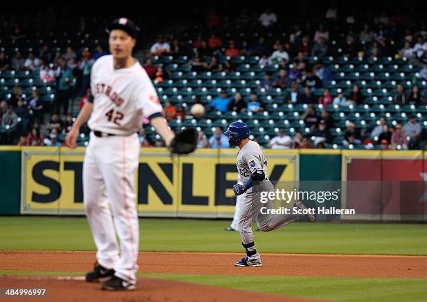 Omar Infante of the Kansas City Royals rounds second base after hitting a solo home run in the first inning off Lucas Harrell of the Houston Astros...