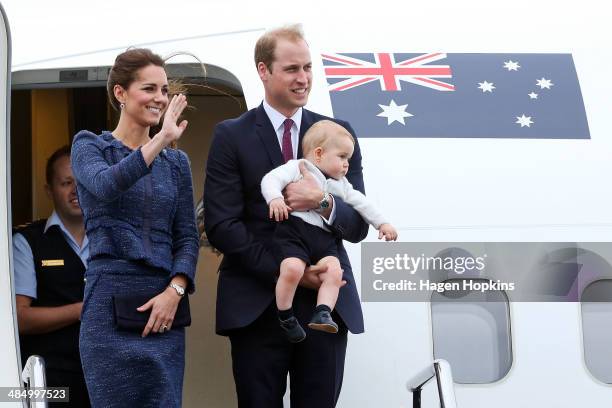 Catherine, Duchess of Cambridge, Prince William, Duke of Cambridge and Prince George of Cambridge wave to the crowd before boarding a Royal...