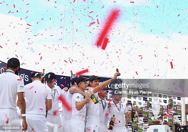 Alastair Cook of England lifts the Ashes Urn during day four of the 5th Investec Ashes Test match between England and Australia at The Kia Oval on...