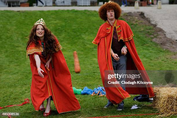 Newly crowned Queen and King of Redheads, Grainne Keena and Alan Reidy participate in the carrot throwing event at the Irish Redhead Convention which...