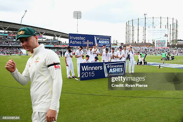 Michael Clarke of Australia looks on as England celebrate during day four of the 5th Investec Ashes Test match between England and Australia at The...