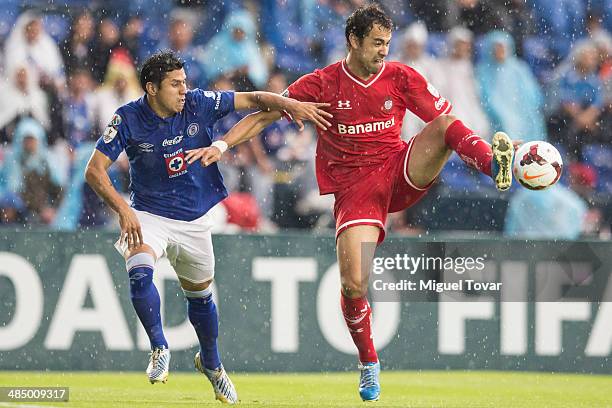 Julio Dominguez of Cruz Azul fights for the ball with Pablo Velazquez of Toluca during a final first leg between Cruz Azul and Toluca as part of the...