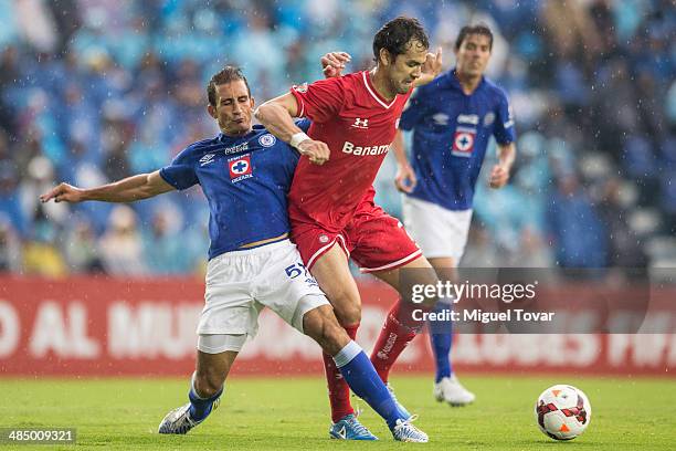 Emanuel Loeschbor of Cruz Azul fights for the ball with Pablo Velazquez of Toluca during a final first leg between Cruz Azul and Toluca as part of...