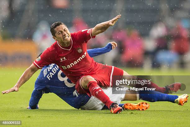 Marco Fabian of Cruz Azul fouls Carlos Esquivel of Toluca during a final first leg between Cruz Azul and Toluca as part of the CONCACAF Champions...