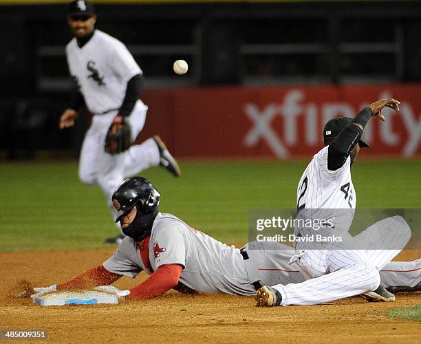 Mike Napoli of the Boston Red Sox steals second base as Alexei Ramirez of the Chicago White Sox tries to tag him during the ninth inning on April 15,...