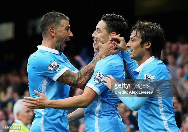 Samir Nasri of Manchester City celebrates scoring his team's second goal with Aleksandar Kolarov and David Silva during the Barclays Premier League...