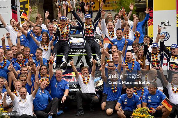 Sebastien Ogier of France and Julien Ingrassia of France celebrate their first position in the final overall during Day Three of the WRC Germany on...