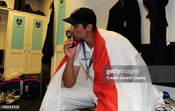 England captain Alastair Cook celebrates with the ashes urn in the dressing rooms after the 5th Investec Ashes Test match between England and...