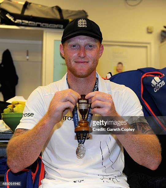 Ben Stokes of England celebrates with the ashes urn in the dressing rooms after the 5th Investec Ashes Test match between England and Australia at...