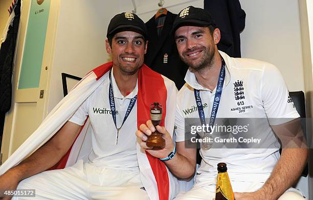 England captain Alastair Cook and James Anderson celebrate with the ashes urn in the dressing rooms after the 5th Investec Ashes Test match between...