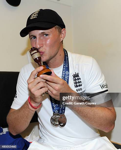 Joe Root of England celebrates with the ashes urn in the dressing rooms after the 5th Investec Ashes Test match between England and Australia at The...