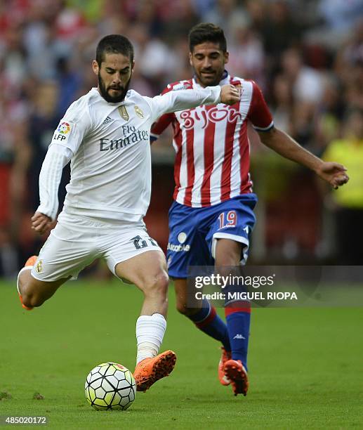 Sporting Gijon's midfielder Carlos Carmona vies with Real Madrid's forward Jese Rodriguez during the Spanish league football match Sporting Gijon vs...