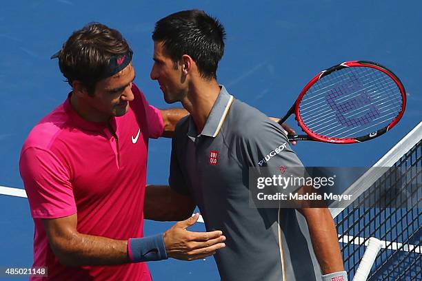 Novak Djokovic of Serbia congratulates Roger Federer of Switzerland after during their final round match on Day 9 of the Western & Southern Open at...