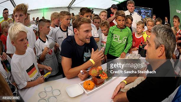Benedikt Hoewedes is seen during the closing event of the 'DFB Ehrenrunde' on August 23, 2015 in Kamen, Germany.