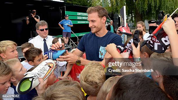 Benedikt Hoewedes gives autographs during the 'DFB Ehrenrunde' on August 23, 2015 in Kamen, Germany.