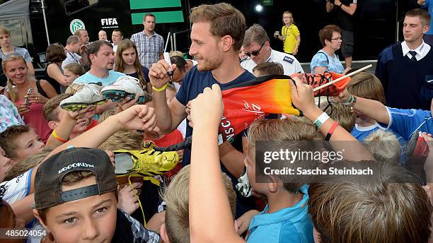 Benedikt Hoewedes gives autographs during the 'DFB Ehrenrunde' on August 23, 2015 in Kamen, Germany.