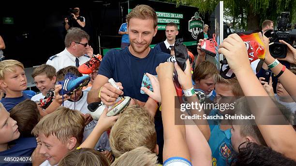 Benedikt Hoewedes gives autographs during the 'DFB Ehrenrunde' on August 23, 2015 in Kamen, Germany.