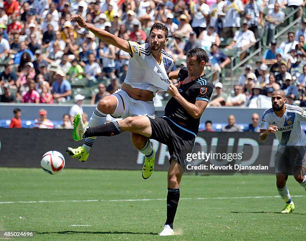 Omar Gonzalez of Los Angeles Galaxy gets his shirt pulled by Andrew Jacobson of New York City FC as reaches for the cross over pass at StubHub Center...