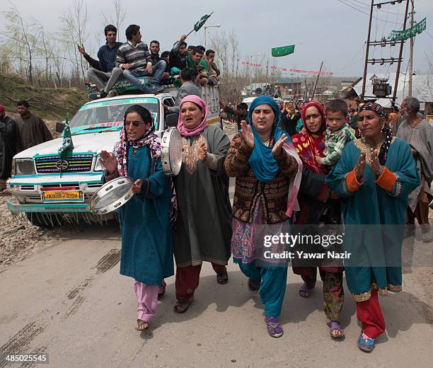 Supporters of Kashmir's main opposition political party, Peoples Democratic Party's leader Mehbooba Mufti, and candidate for South Kashmir dance and...