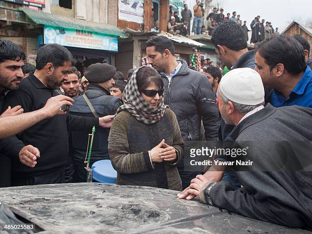 Supporters of Kashmir's main opposition political party, Peoples Democratic Party's leader Mehbooba Mufti, and candidate for South Kashmir talks with...