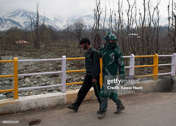 Supporter of Kashmir's main opposition political party, Peoples Democratic Party's leader Mehbooba Mufti, and candidate for South Kashmir wears flags...