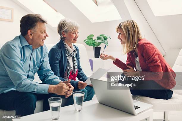 senior couple meeting with financial advisor. - legal assistance stock pictures, royalty-free photos & images