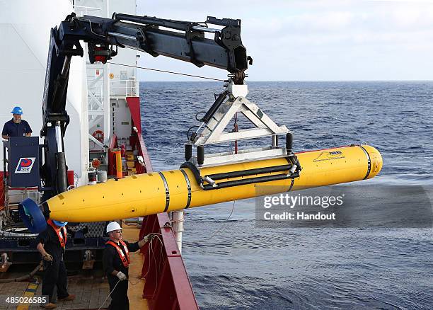 In this handout image provided by Commonwealth of Australia, Department of Defence, Phoenix Autonomous Underwater Vehicle Bluefin-21 is craned over...