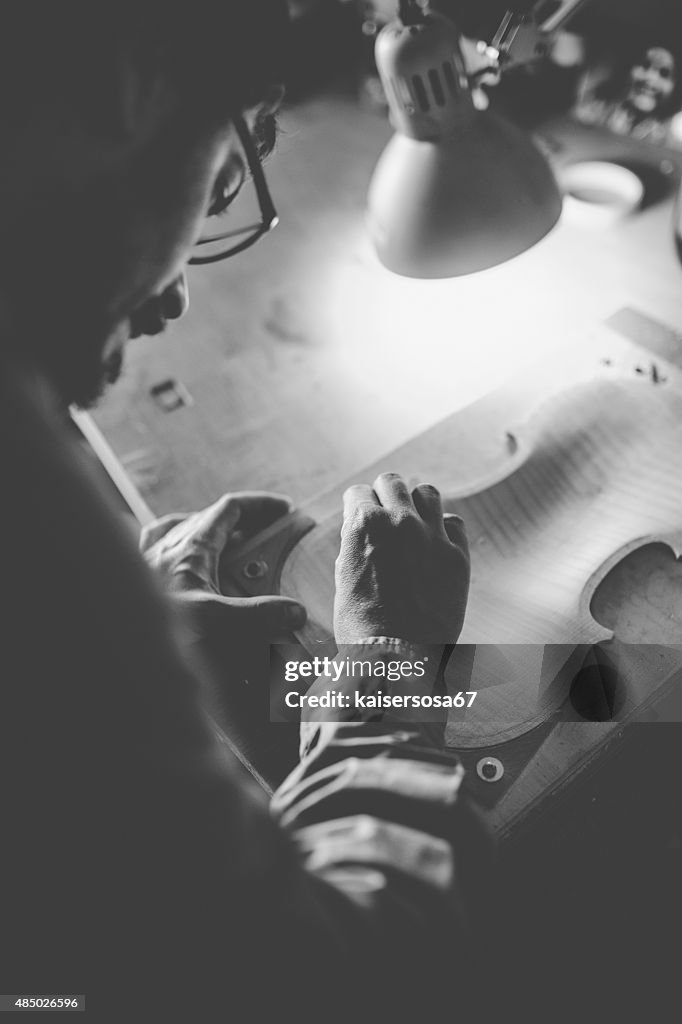 Luthier making a violin