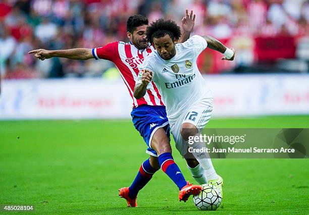 Marcelo Vieira da Silva of Real Madrid duels for the ball with Carlos Carmona of Real Sporting de Gijon during the La Liga match between Sporting...