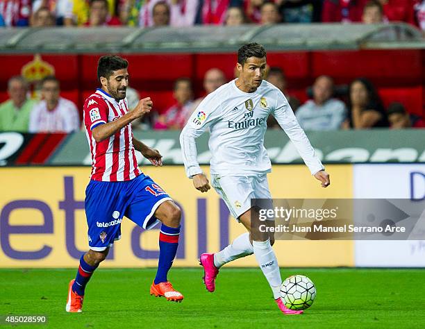 Cristiano Ronaldo of Real Madrid duels for the ball with Carlos Carmona of Real Sporting de Gijon during the La Liga match between Sporting Gijon and...
