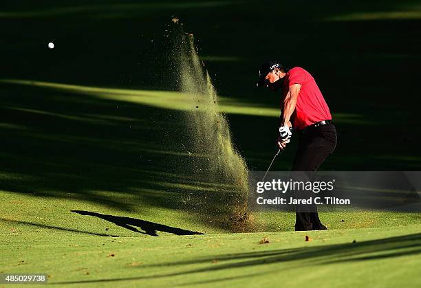 Tiger Woods plays his second shot from the fairway on the 17th hole during the final round of the Wyndham Championship at Sedgefield Country Club on...