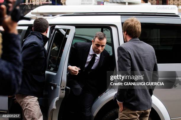 South African Paralympic track star Oscar Pistorius arrives at the court in Pretoria on April 16, 2014. South African prosecutor Gerrie Nel indicated...