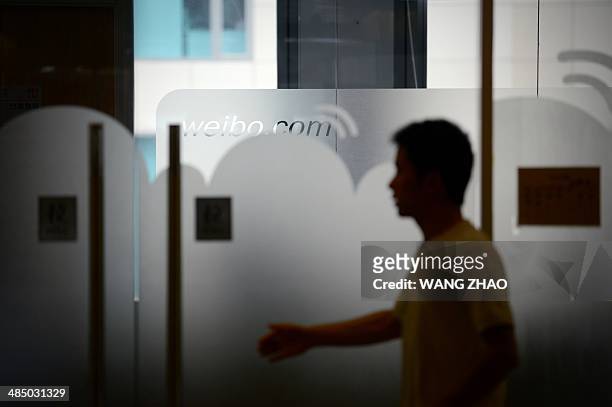 Man walks into an office of Sina Weibo, widely known as China's version of Twitter, in Beijing on April 16. Sina Weibo is set to go public in the US...