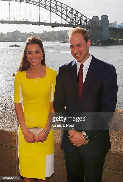 Prince William, Duke of Cambridge and Catherine, Duchess of Cambridge pose in front of the Sydney Harbour Bridge at a reception at the Sydney Opera...