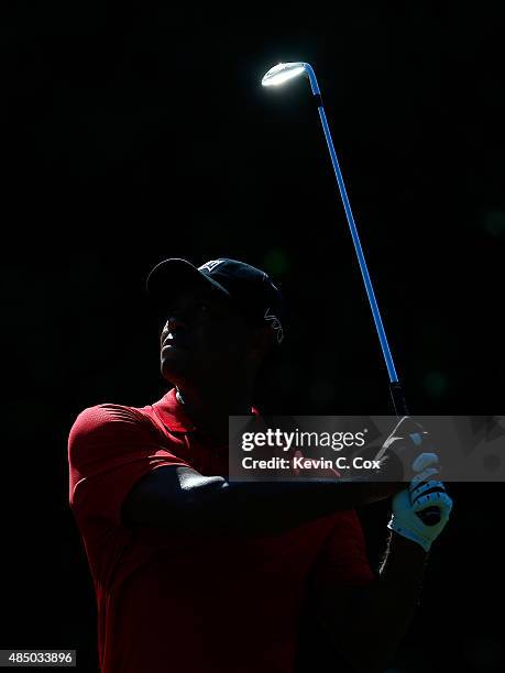 Tiger Woods plays his second shot on the 13th hole during the final round of the Wyndham Championship at Sedgefield Country Club on August 23, 2015...