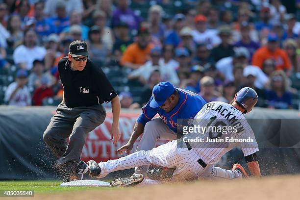 Charlie Blackmon of the Colorado Rockies is tagged out by third baseman Juan Uribe of the New York Mets for the third out of the sixth inning as...