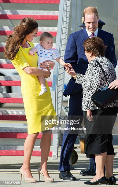 Prince George of Cambridge shakes the Govenor General's wife, Lynne Cosgrove's hand as he arrives with Prince William, Duke of Cambridge and...