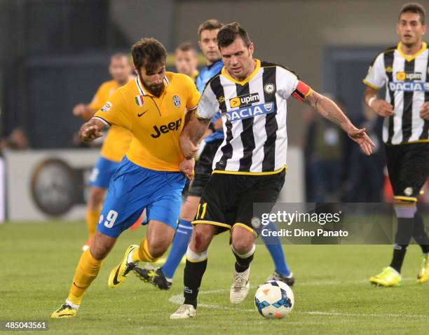 Mirko Vucinic of Juventus competes with Maurizio Domizzi of Udinese Calcio during the Serie A match between Udinese Calcio and Juventus at Stadio...