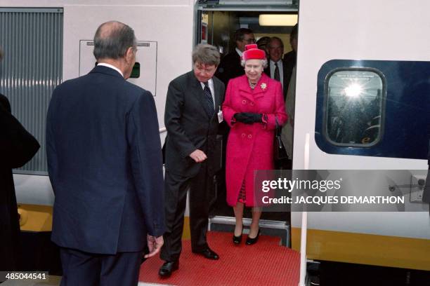 French President François Mitterrand welcomes Queen Elizabeth II during the inauguration of the Channel Tunnel, on May 6 in Coquelles. AFP PHOTO...